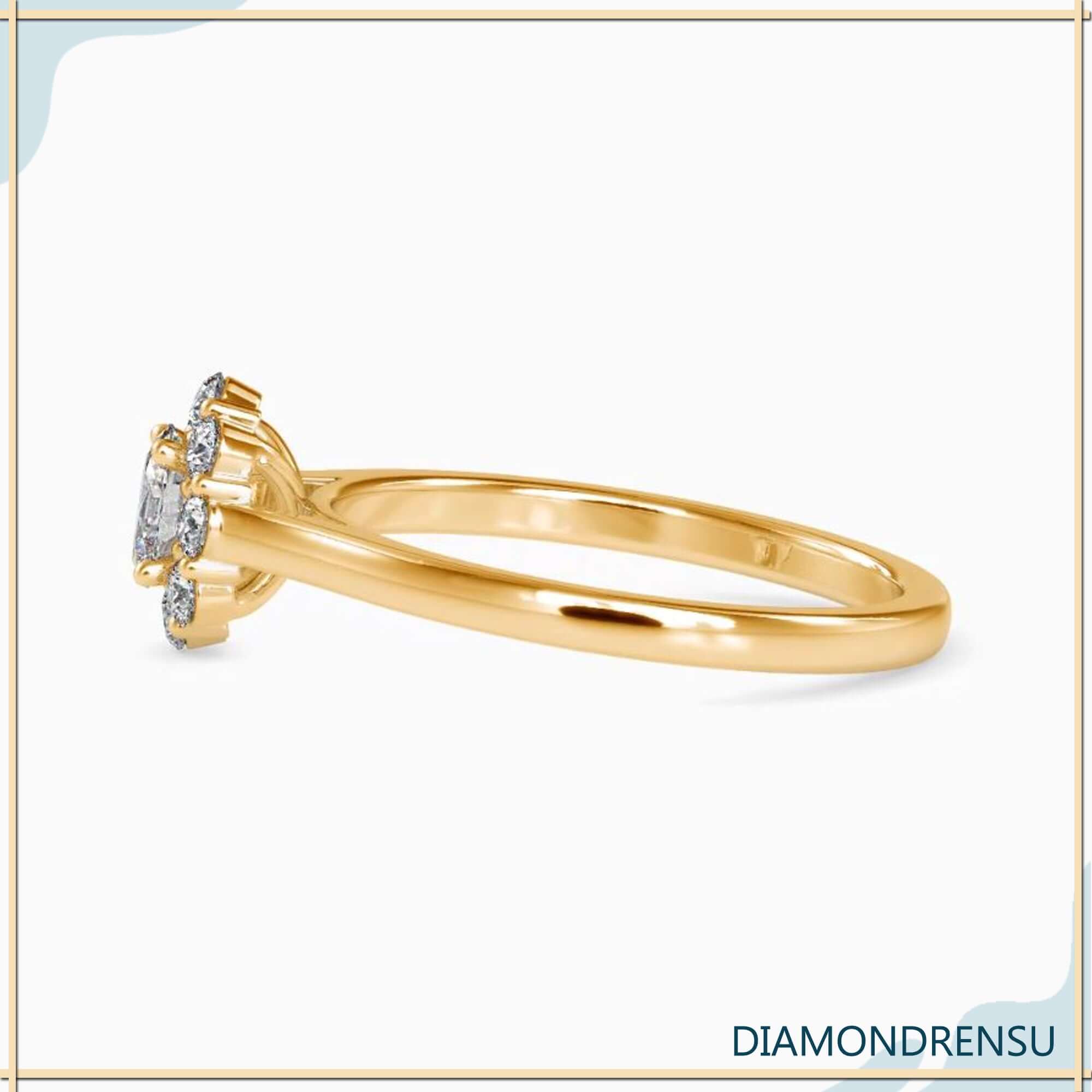 Yellow gold cluster ring with oval diamond centre and 4 prong setting.