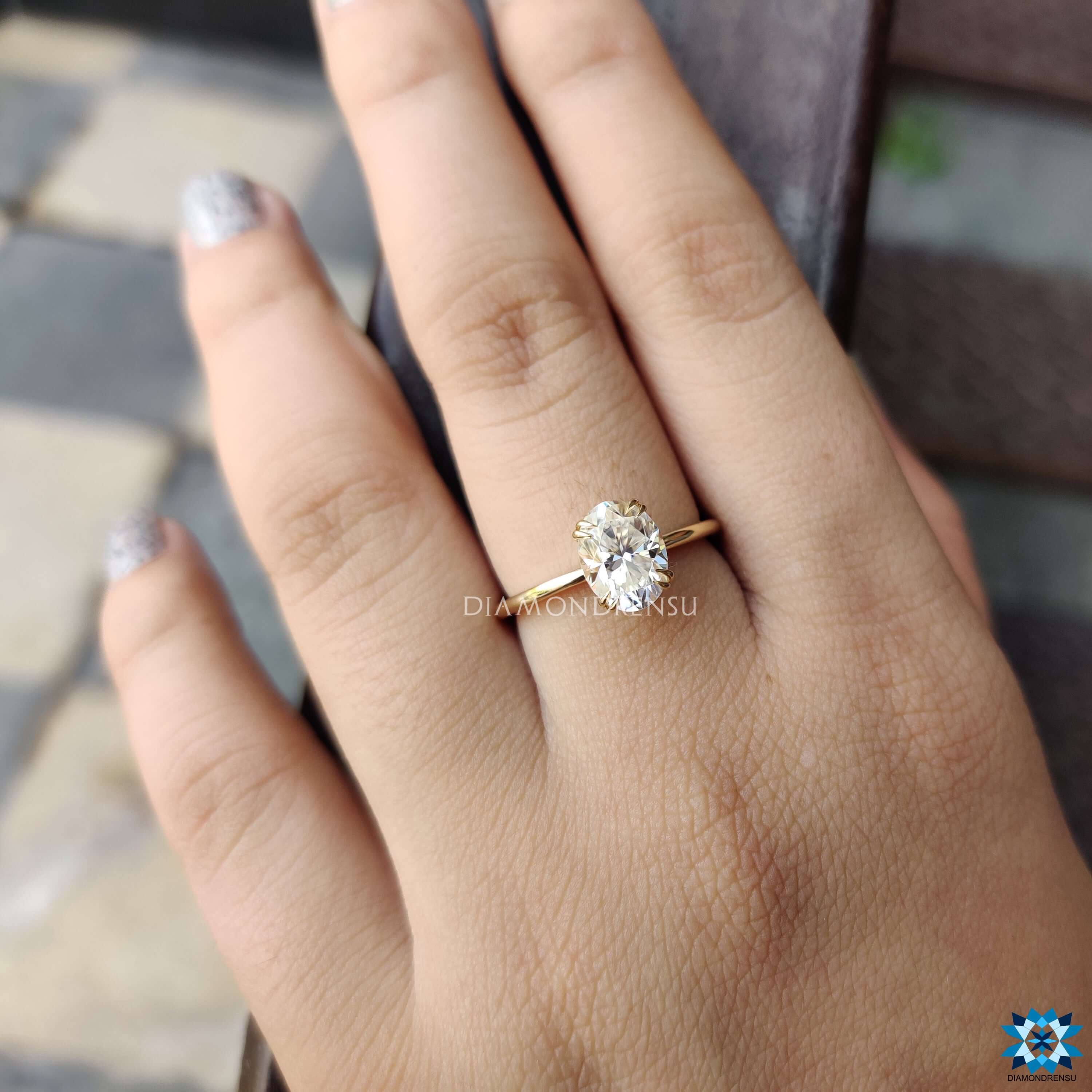 Yellow gold moissanite solitaire ring with elegant claws.