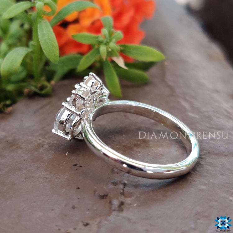 Vintage moissanite ring featuring five round stones in prong setting.