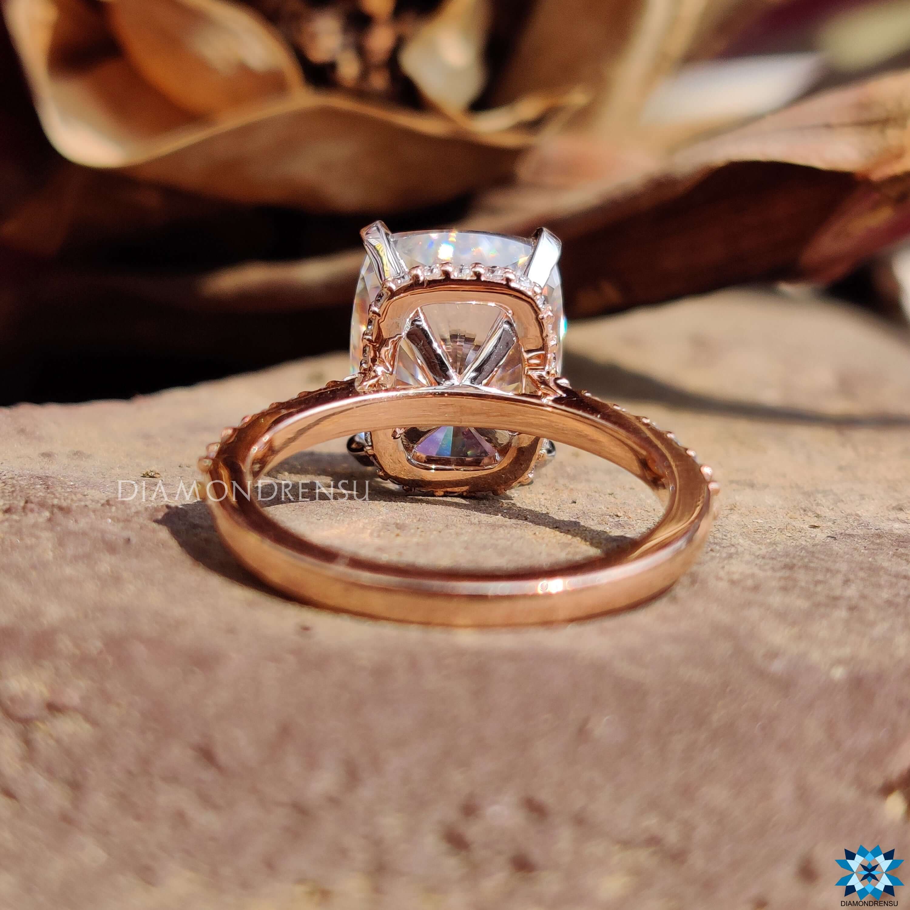 Hidden halo engagement ring with cushion cut moissanite.