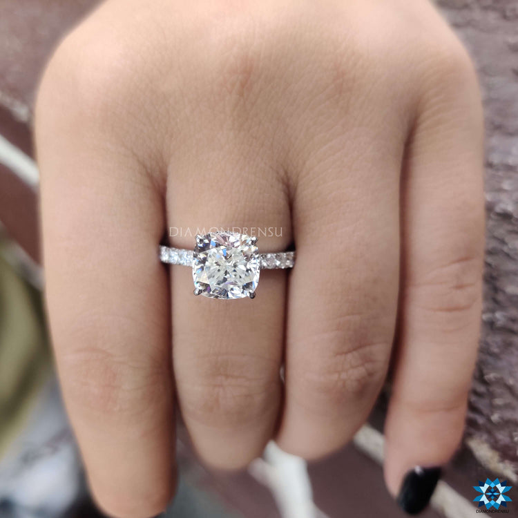 White gold ring featuring cushion moissanite center.