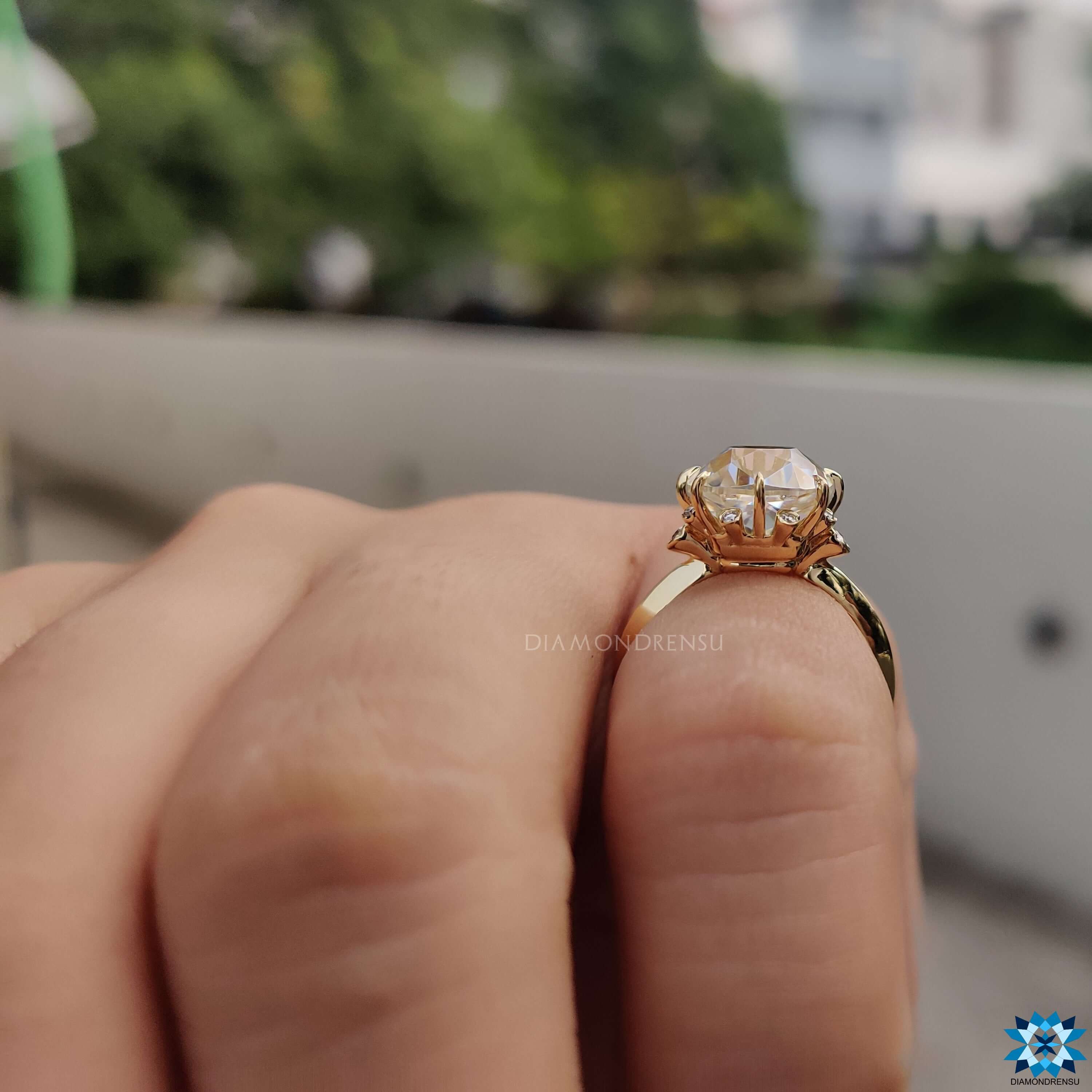 Prong setting engagement ring with cushion cut moissanite.