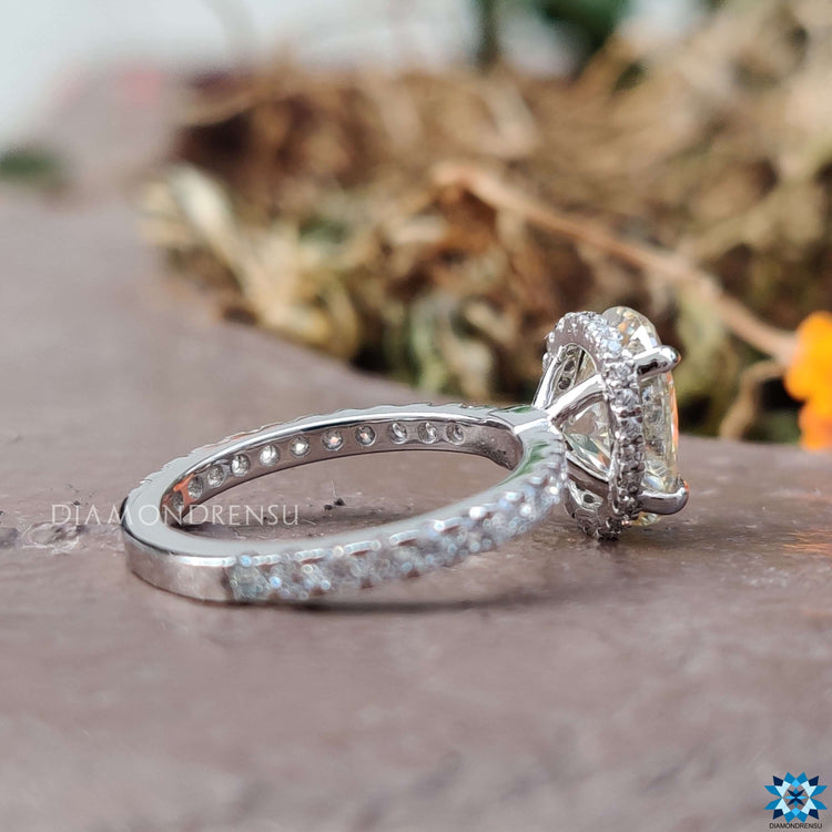 Light yellow moissanite ring with pave and hidden halo.