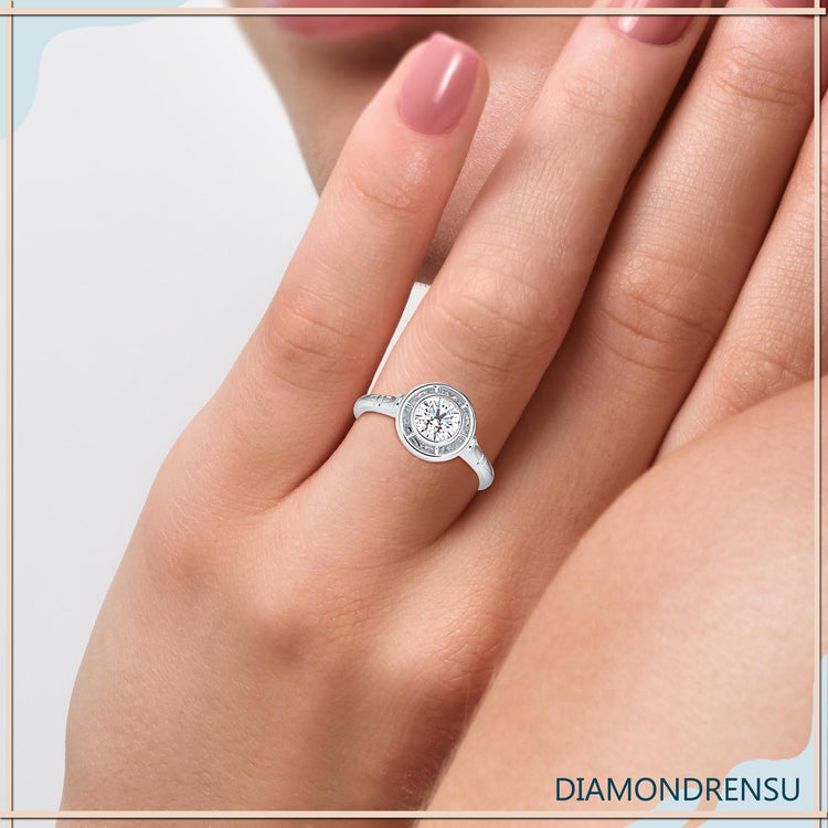 Round diamond ring featuring a handmade bezel setting.