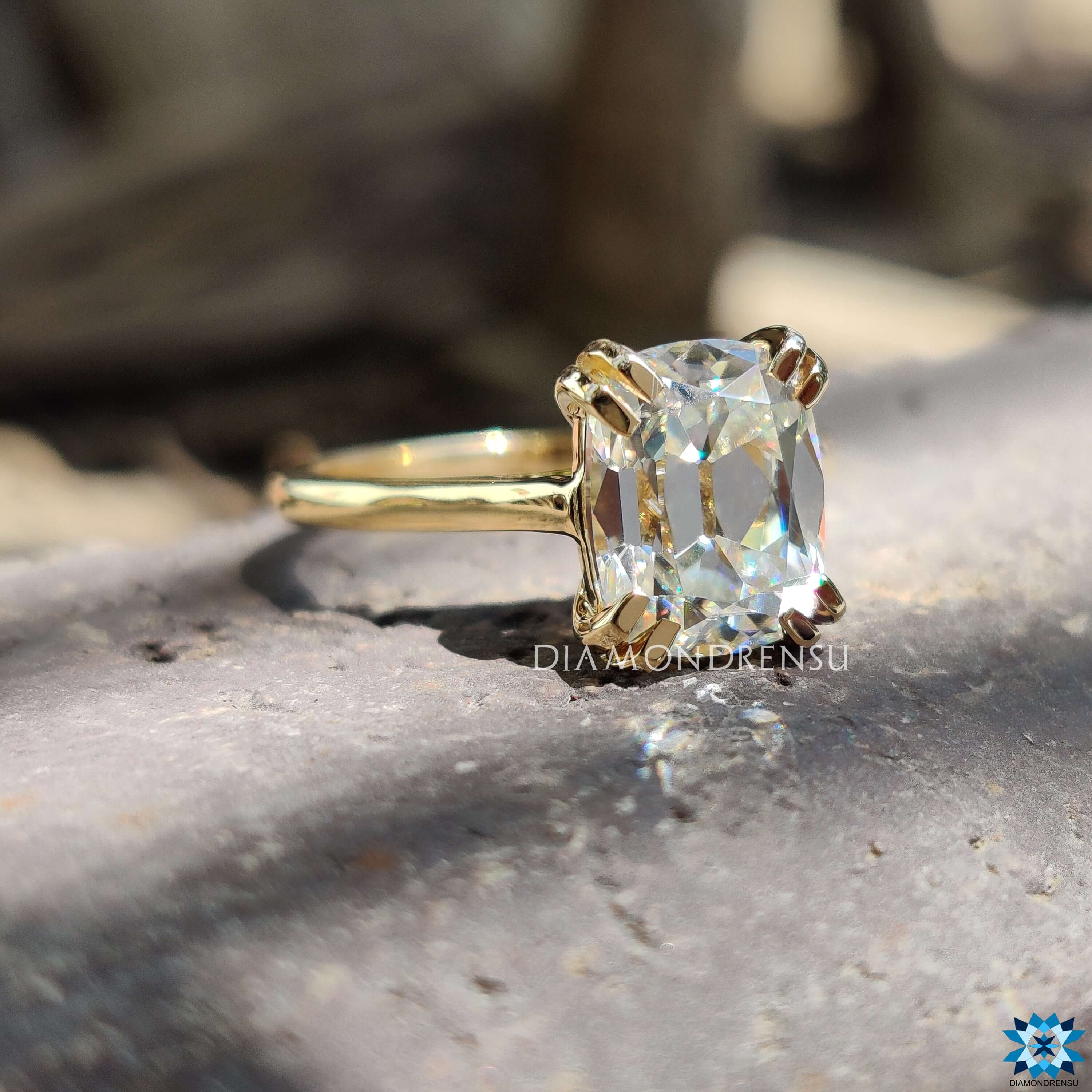 Cathedral setting yellow gold ring with cushion moissanite.