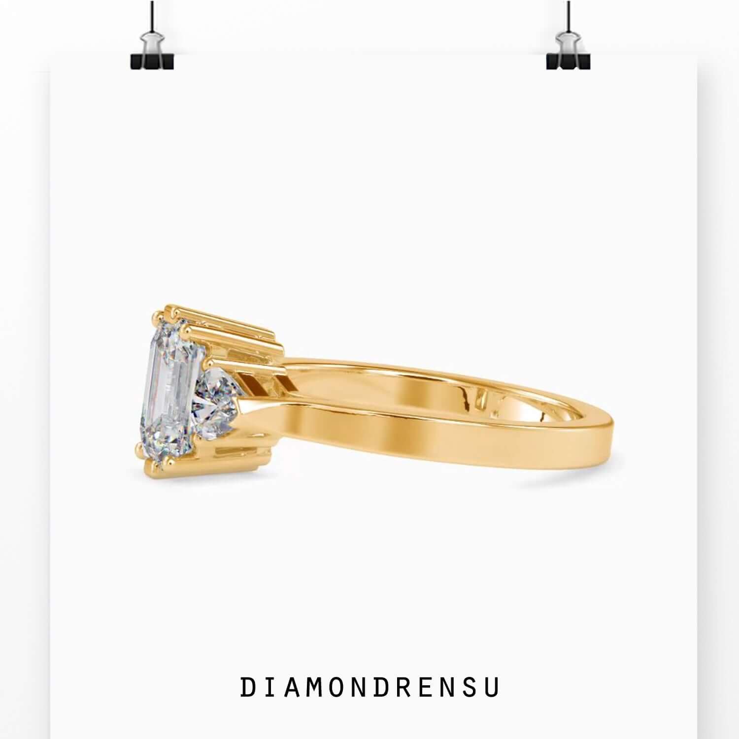 Designer ring with emerald cut diamond and side accents.