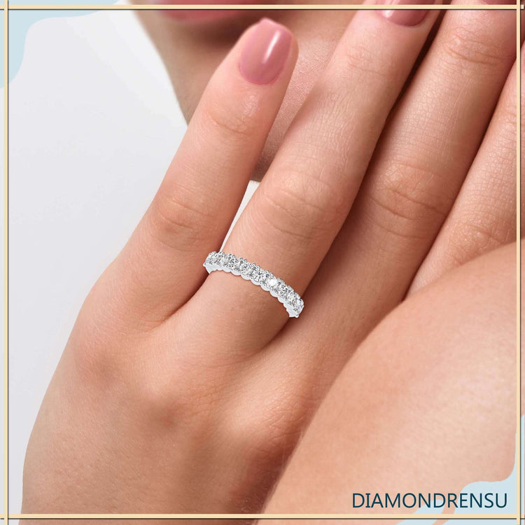 White gold wedding band featuring half eternity diamond setting.