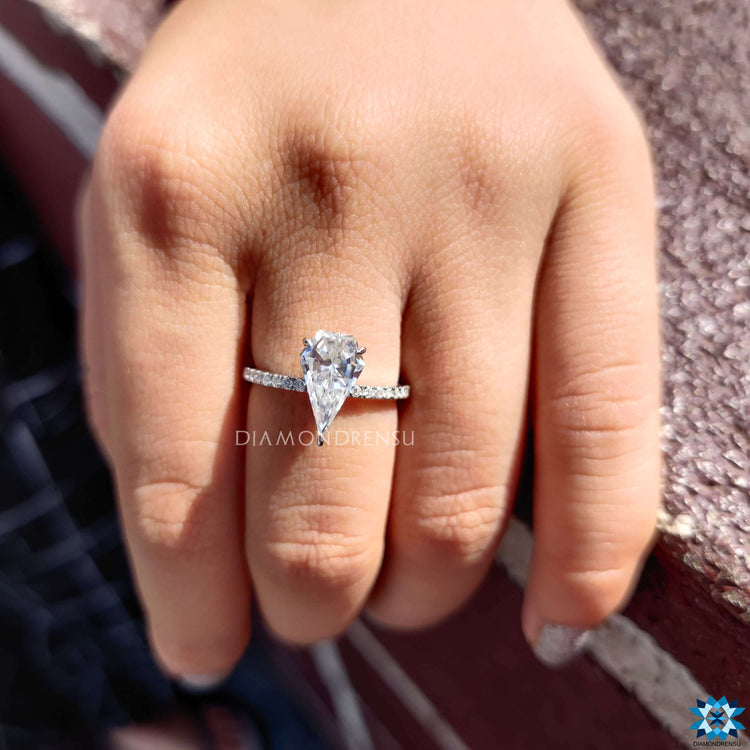 Moissanite pave engagement ring with unique spear cut center.