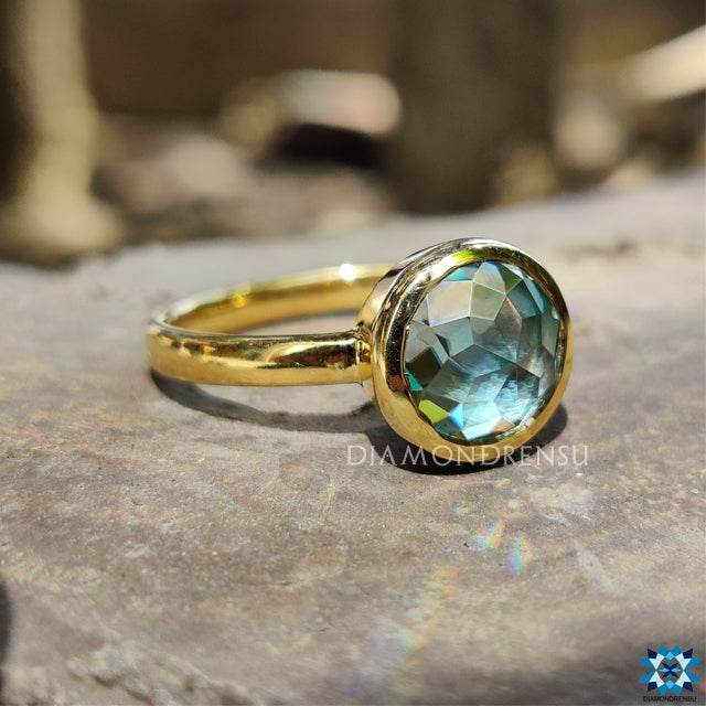 Round rose cut moissanite ring with secure bezel gold setting.