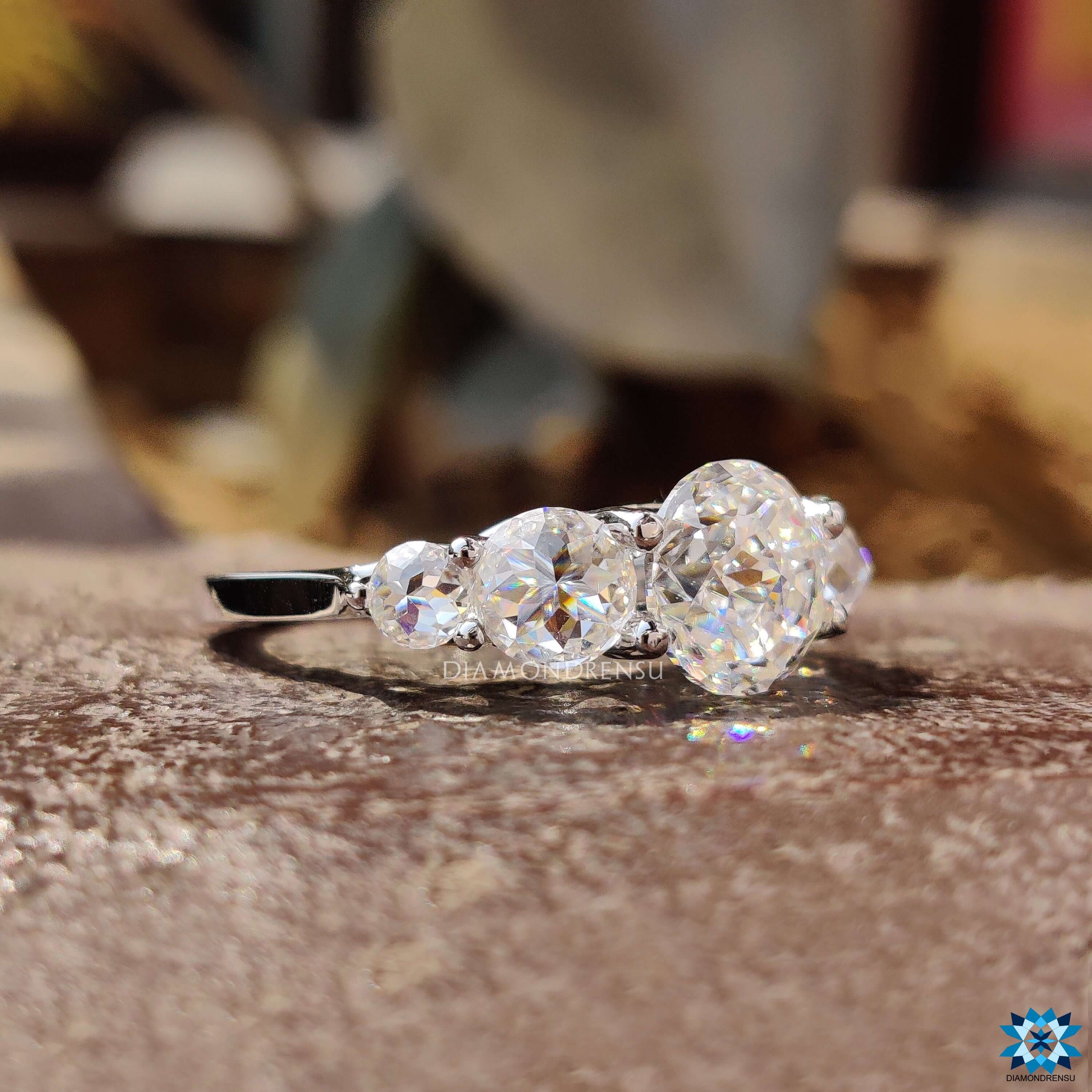 Prong setting ring with jubilee cut and round rose cut moissanite.