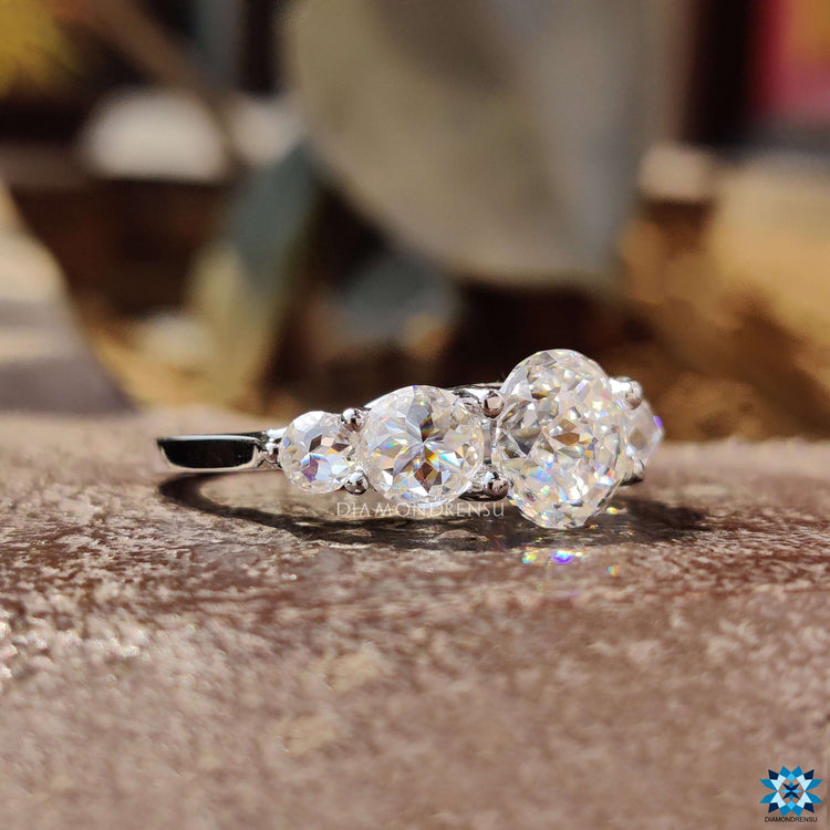 Prong setting ring with jubilee cut and round rose cut moissanite.