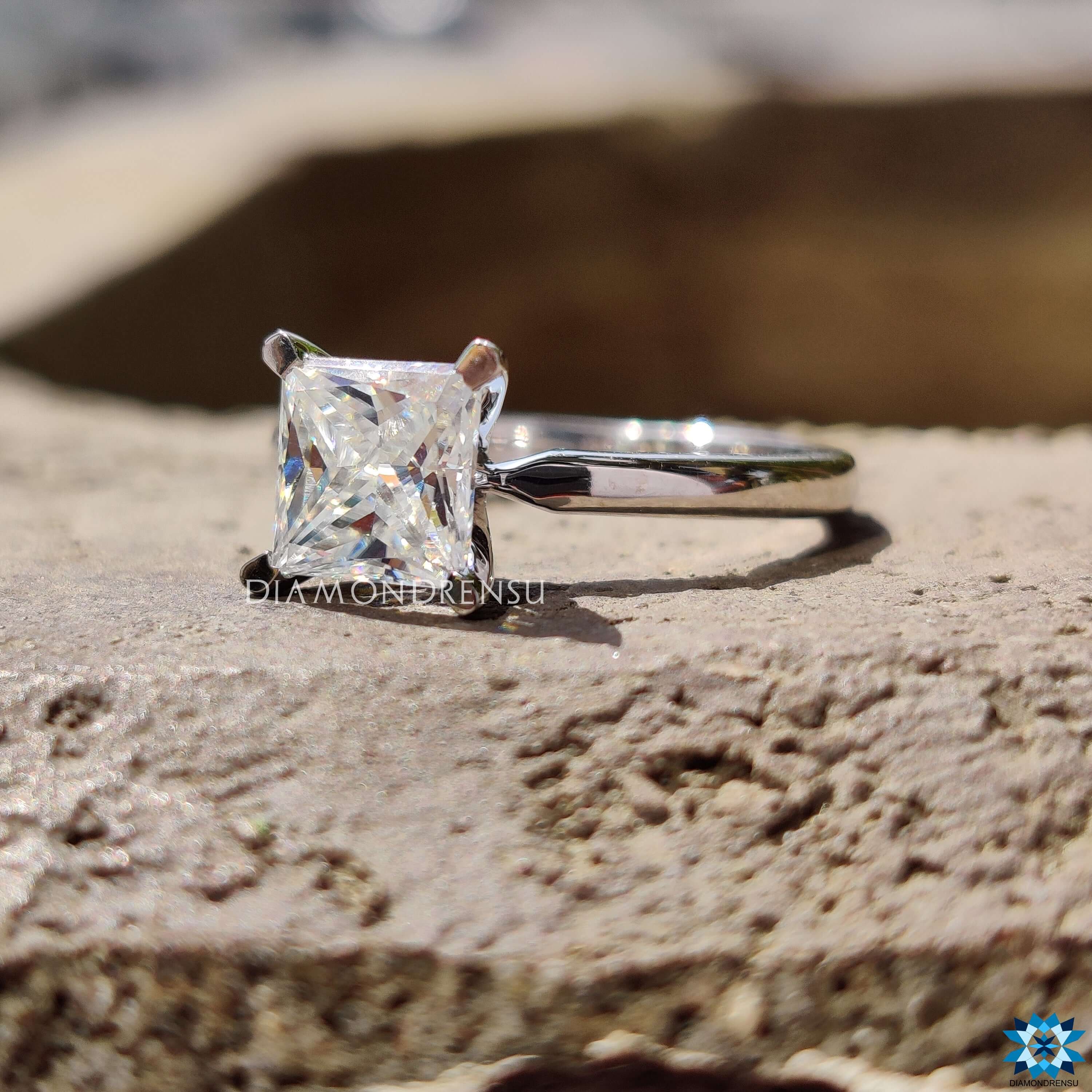 Solitaire moissanite ring in white gold band.