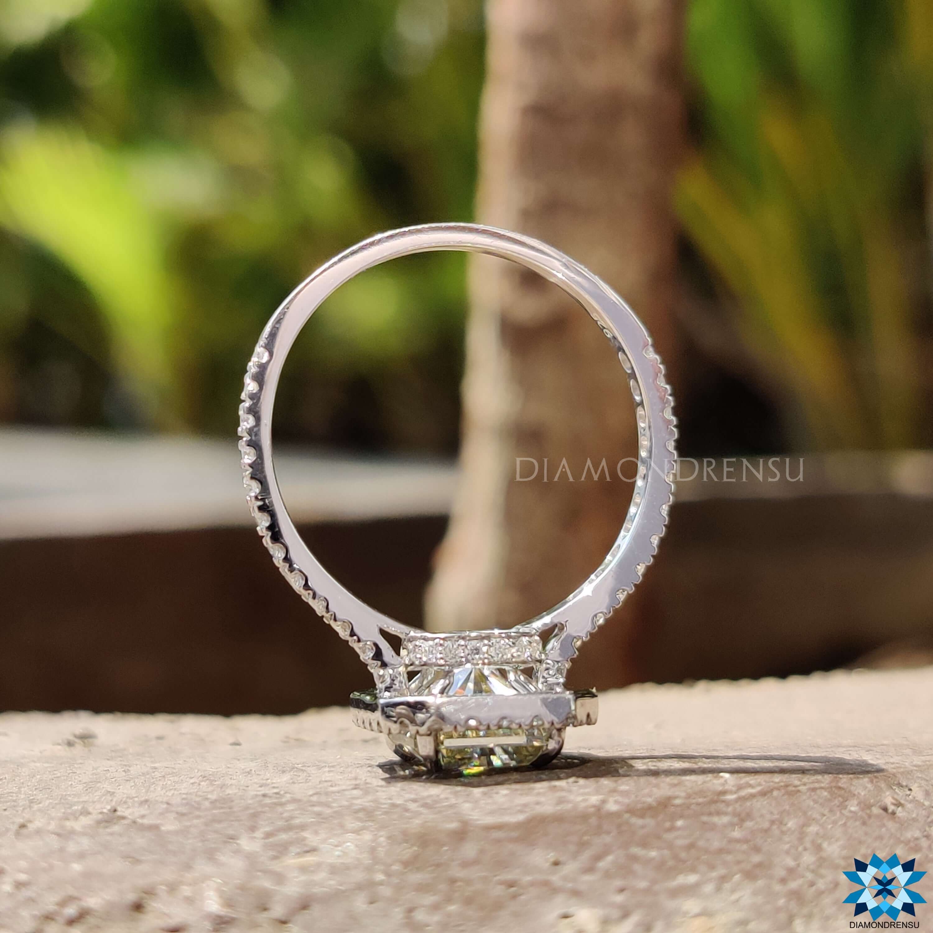 Hidden halo ring with radiant moissanite in a 4 prong claw setting.