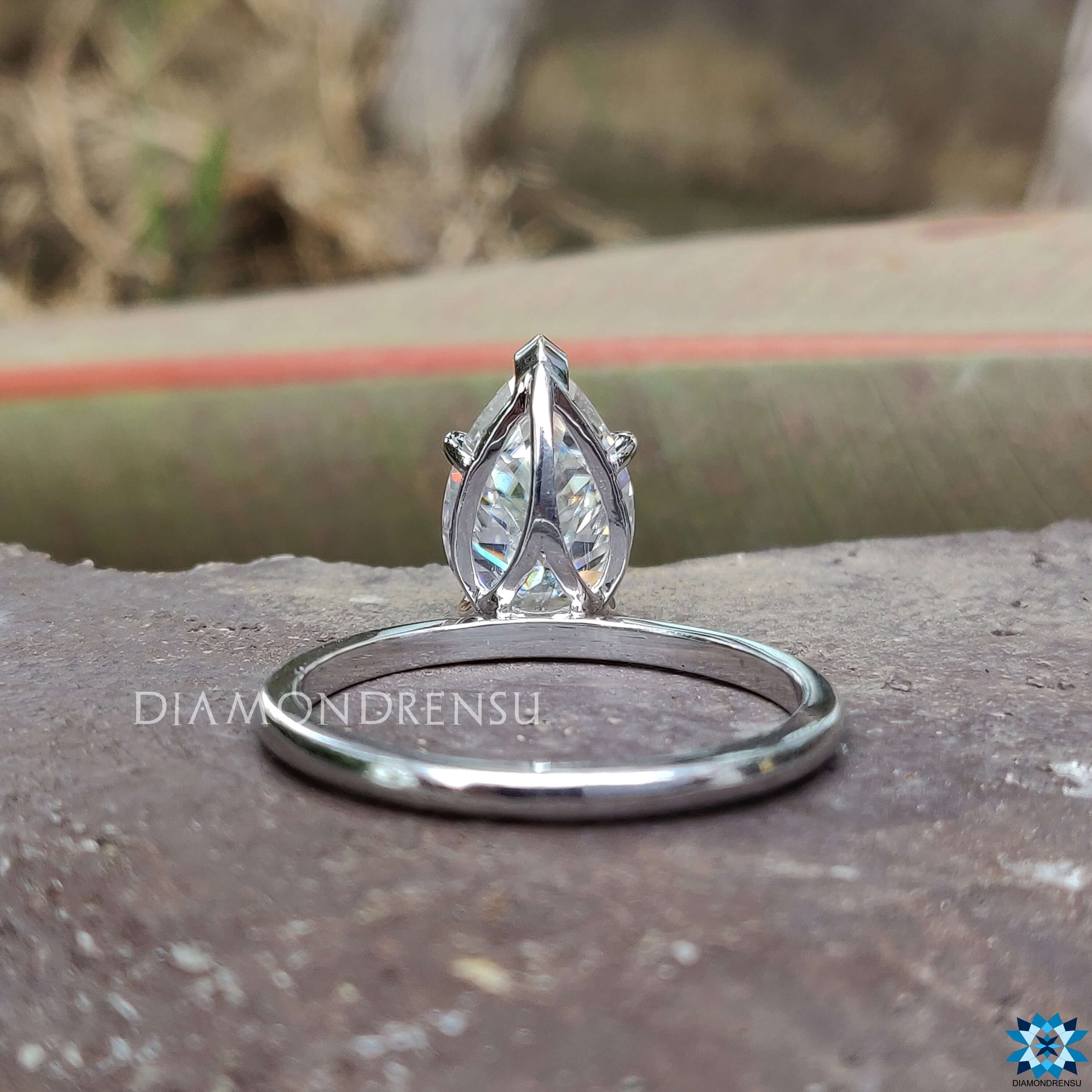 Buy moissanite ring featuring solitaire pear cut design with v shaped prongs.