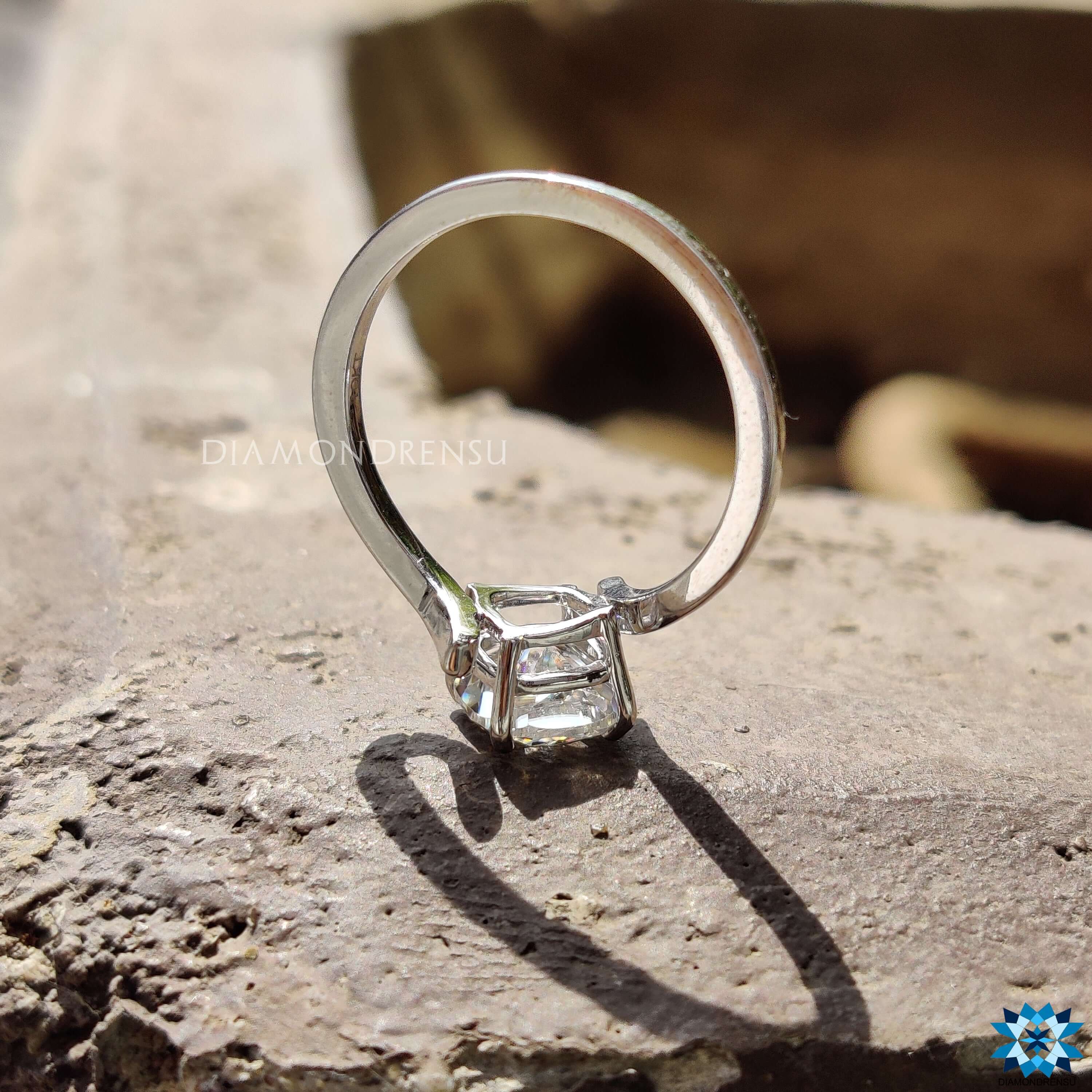 Custom engagement ring with cushion cut moissanite in tension mount.