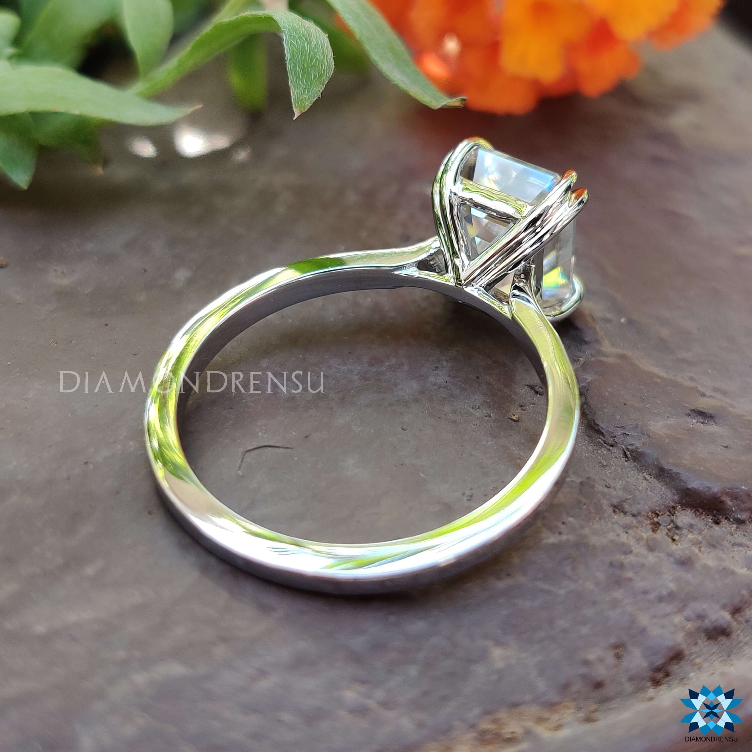 Double claw prong moissanite ring in a solitaire style.