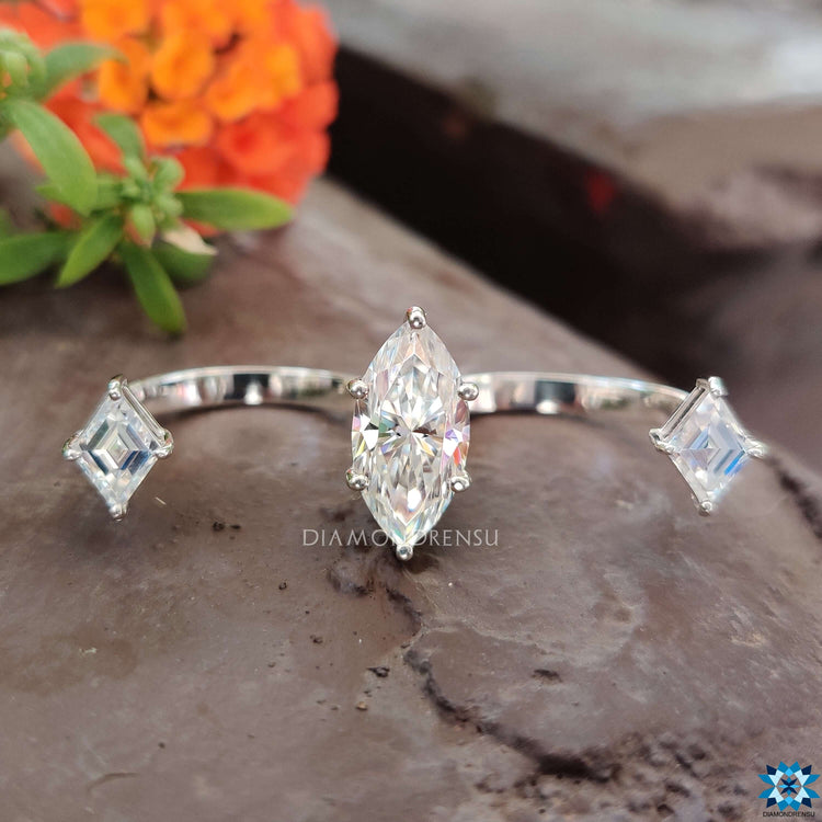 Marquise moissanite center with lozenge side stones.