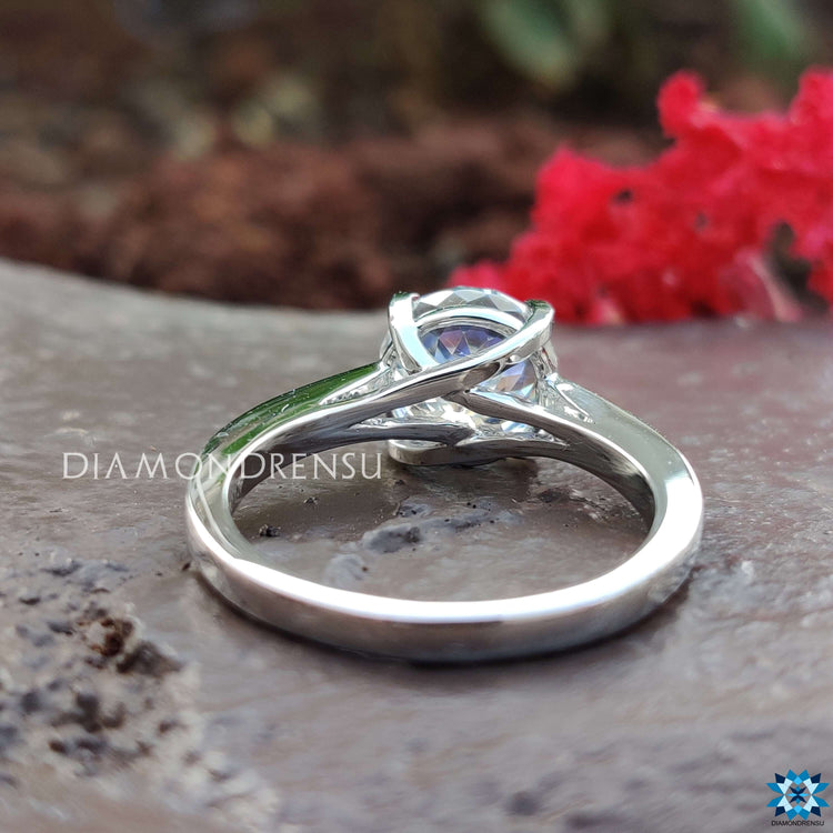 White gold ring with a uniquely cut moissanite center.