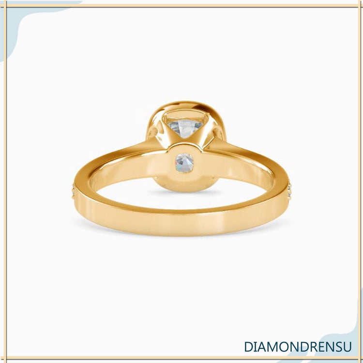 Bezel set cushion cut ring in yellow gold with IGI certification.