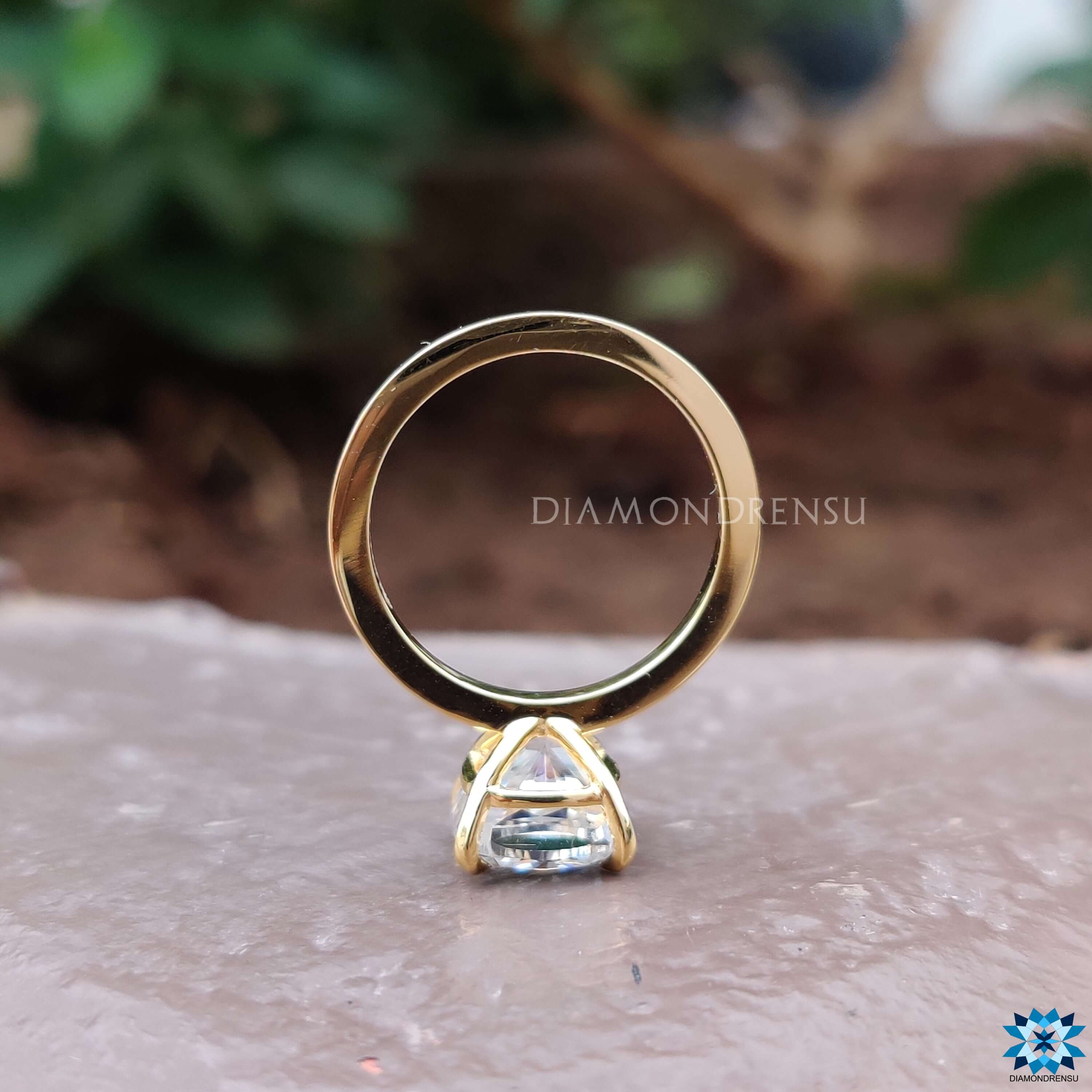 Custom engagement ring with cushion moissanite and solitaire setting.