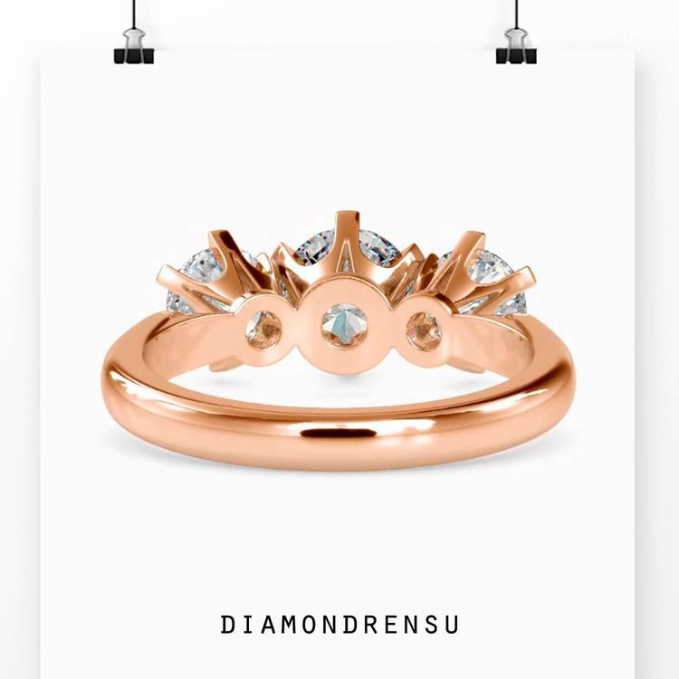 Custom design ring with three round diamonds in tab prongs.