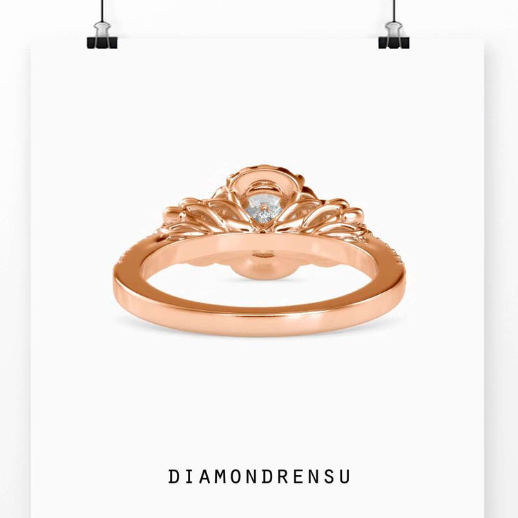Buy engagement ring with round diamond centre and floral halo.