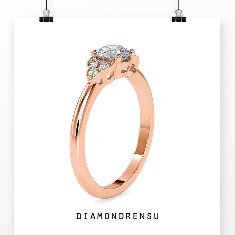 Custom engagement ring with round cut diamonds in rose gold.