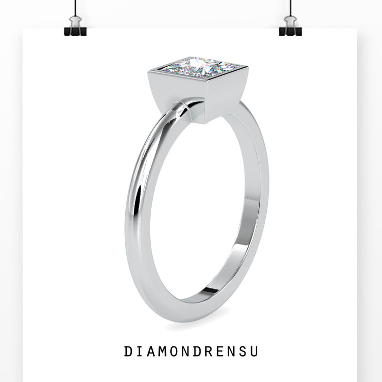 Designer ring in white gold with princess bezel solitaire diamond.
