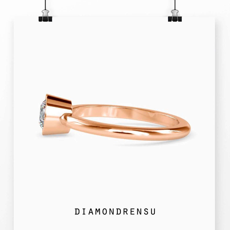 Rose gold bezel ring with IGI certified round lab diamond.