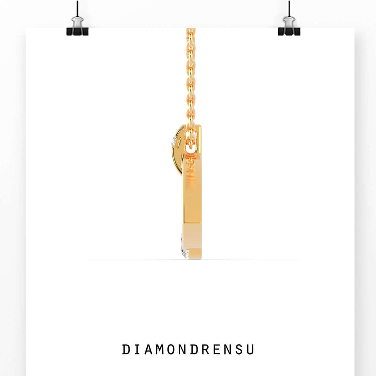 Unique diamond pendant with tension setting in gold finish.