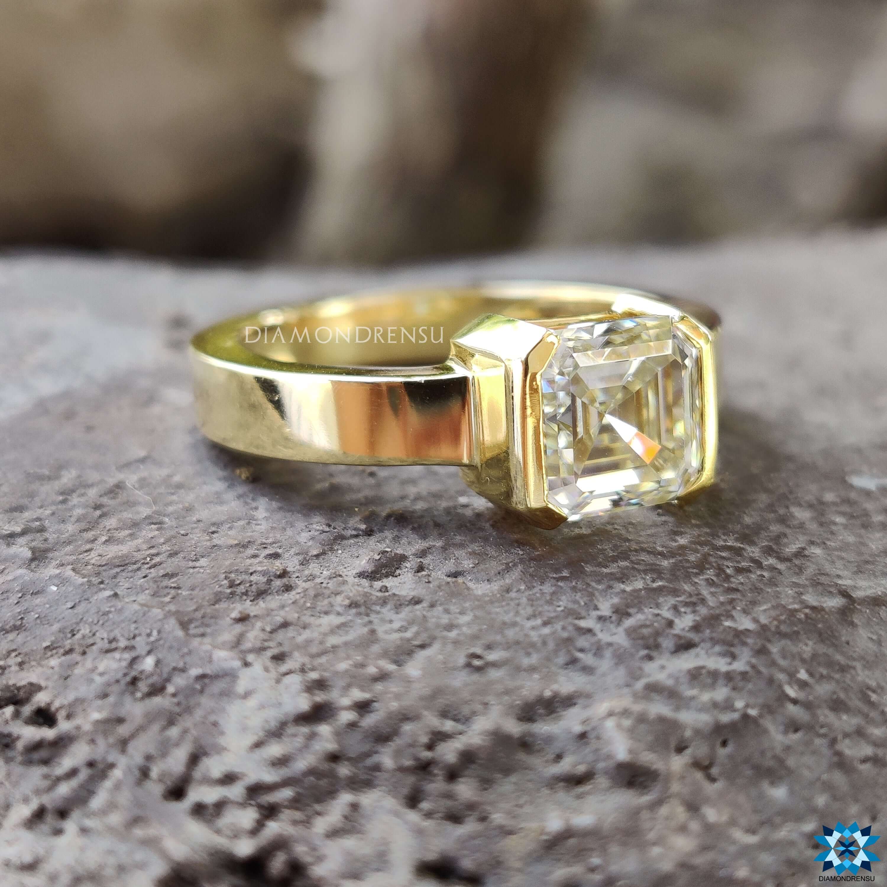 Half bezel set engagement ring with Asscher cut moissanite.