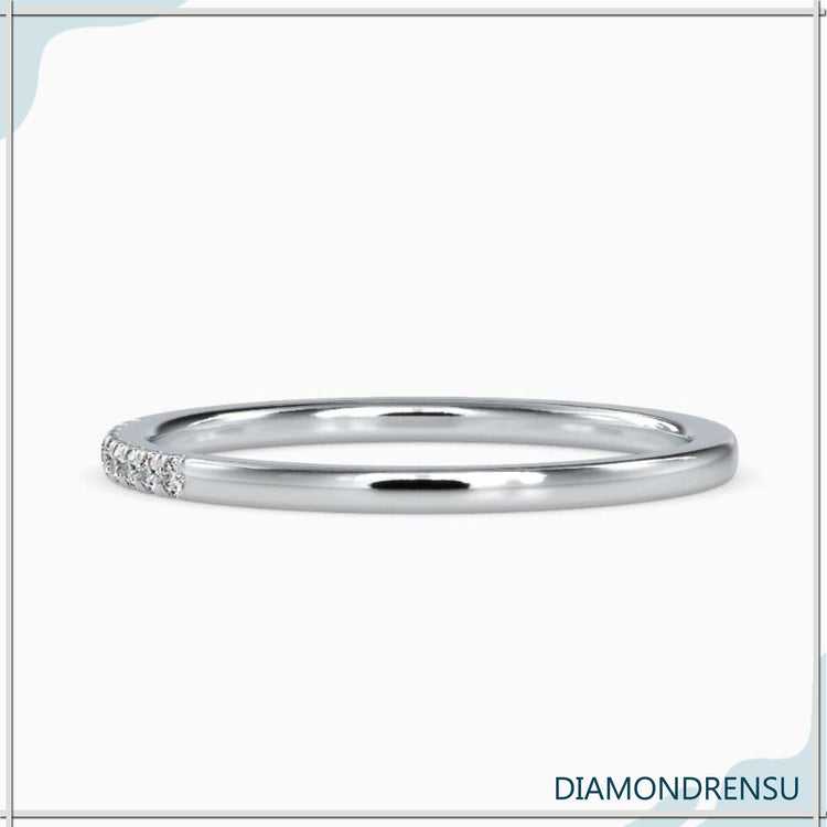 Simple wedding band with lab grown diamond accents.