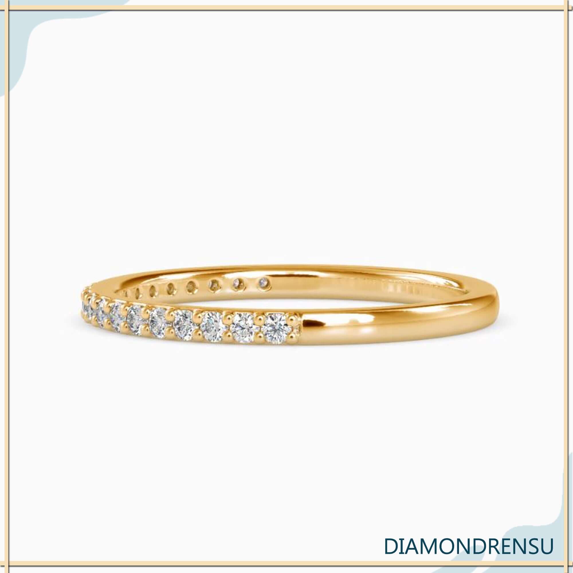 Minimalist wedding band in white gold with flush round diamonds.