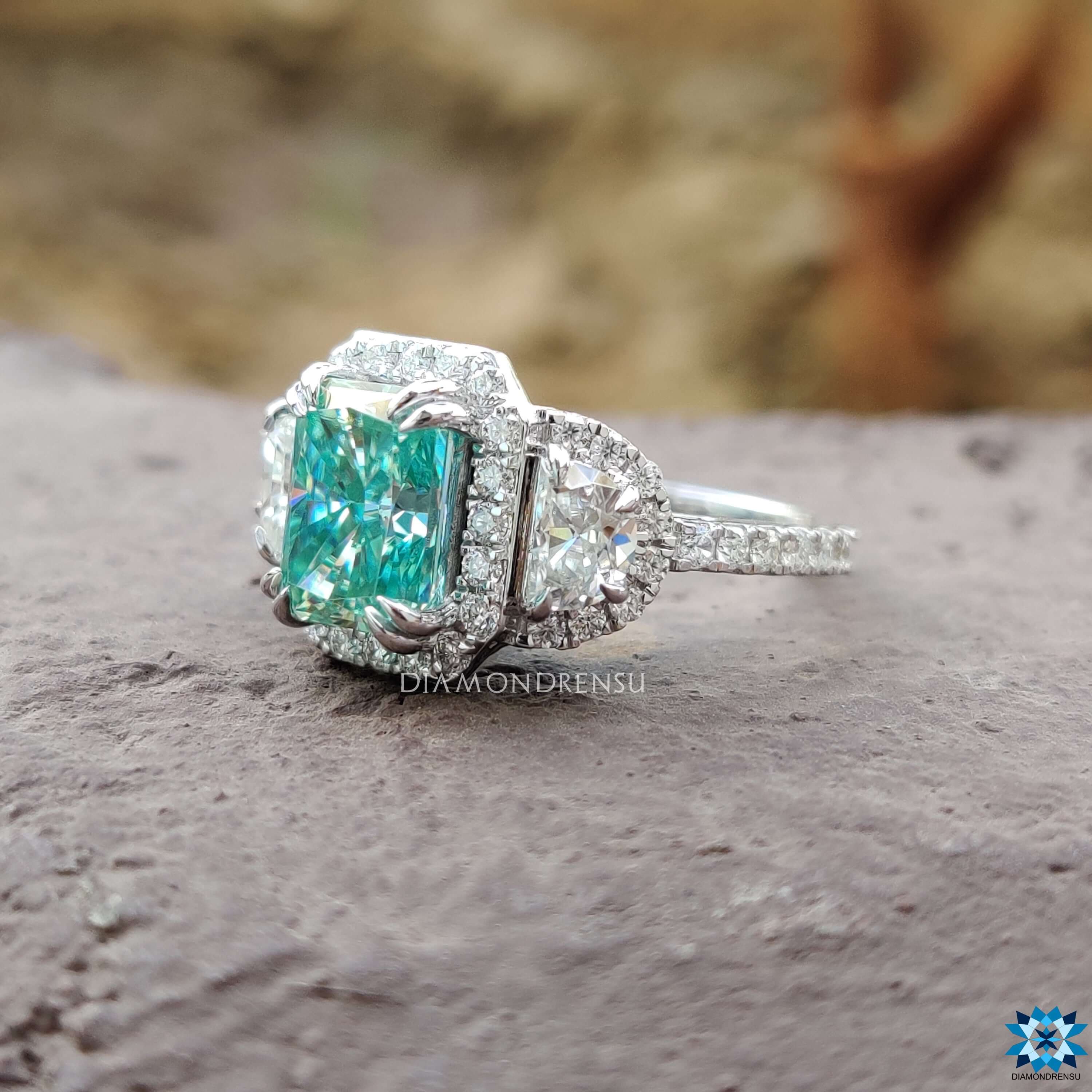 Cyan blue moissanite ring with hidden halo and pave band.