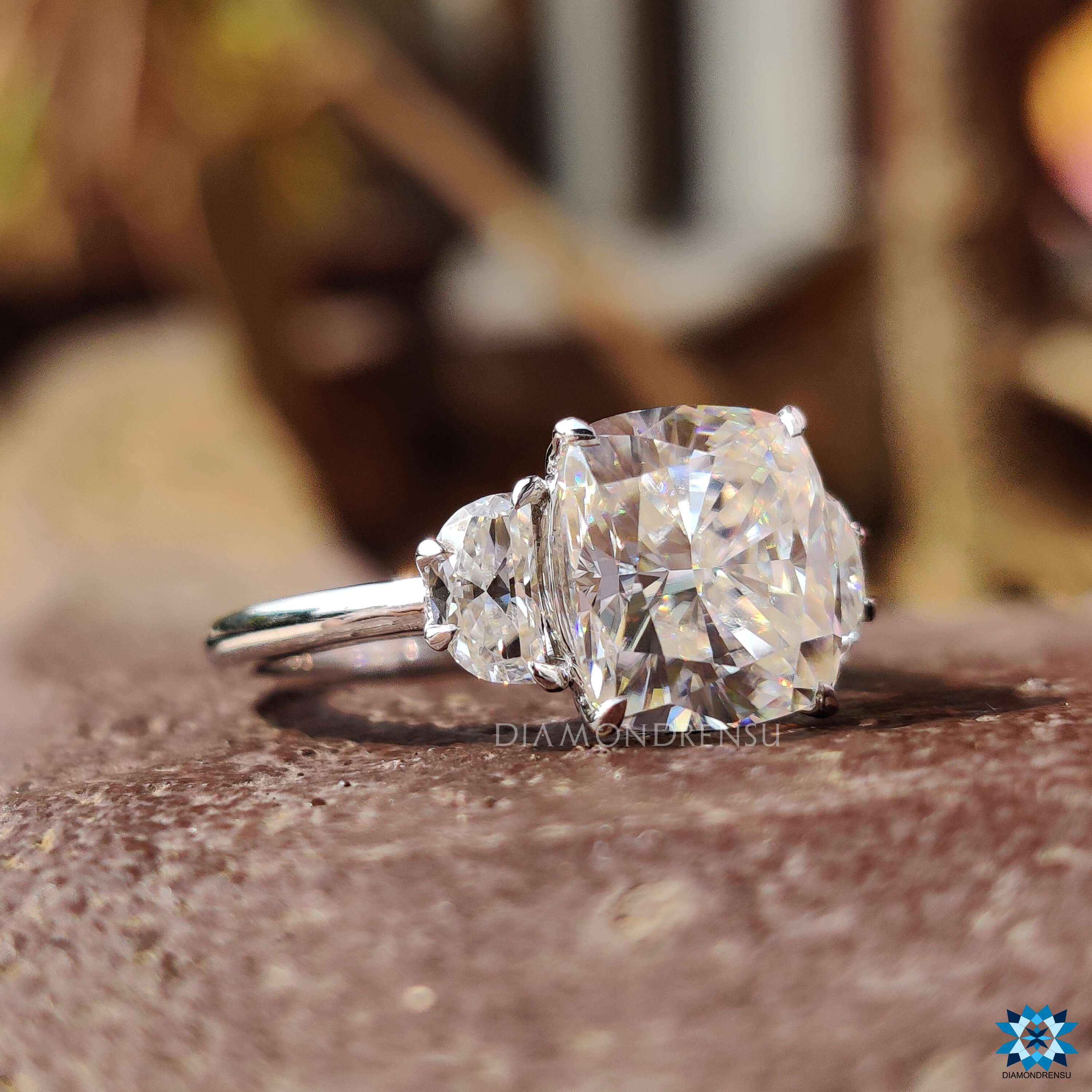 Cushion moissanite ring with cathedral setting in white gold.