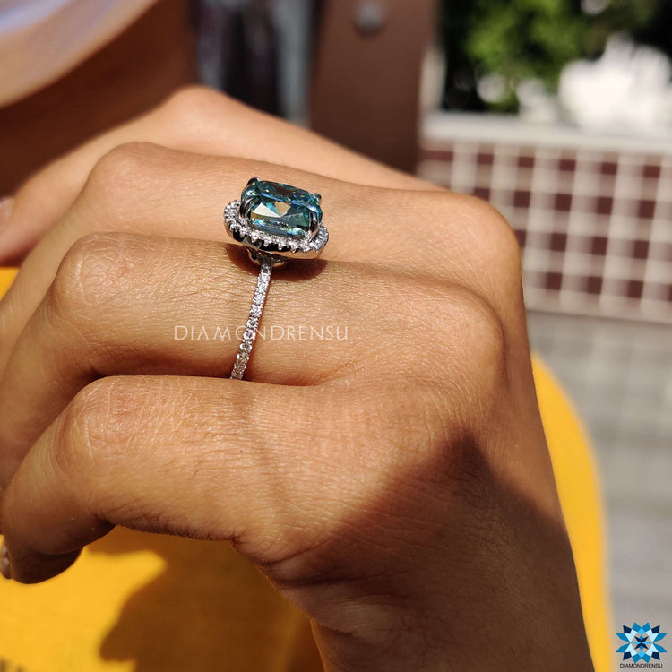 Cushion moissanite engagement ring with handcrafted pave setting and elegant claw design.