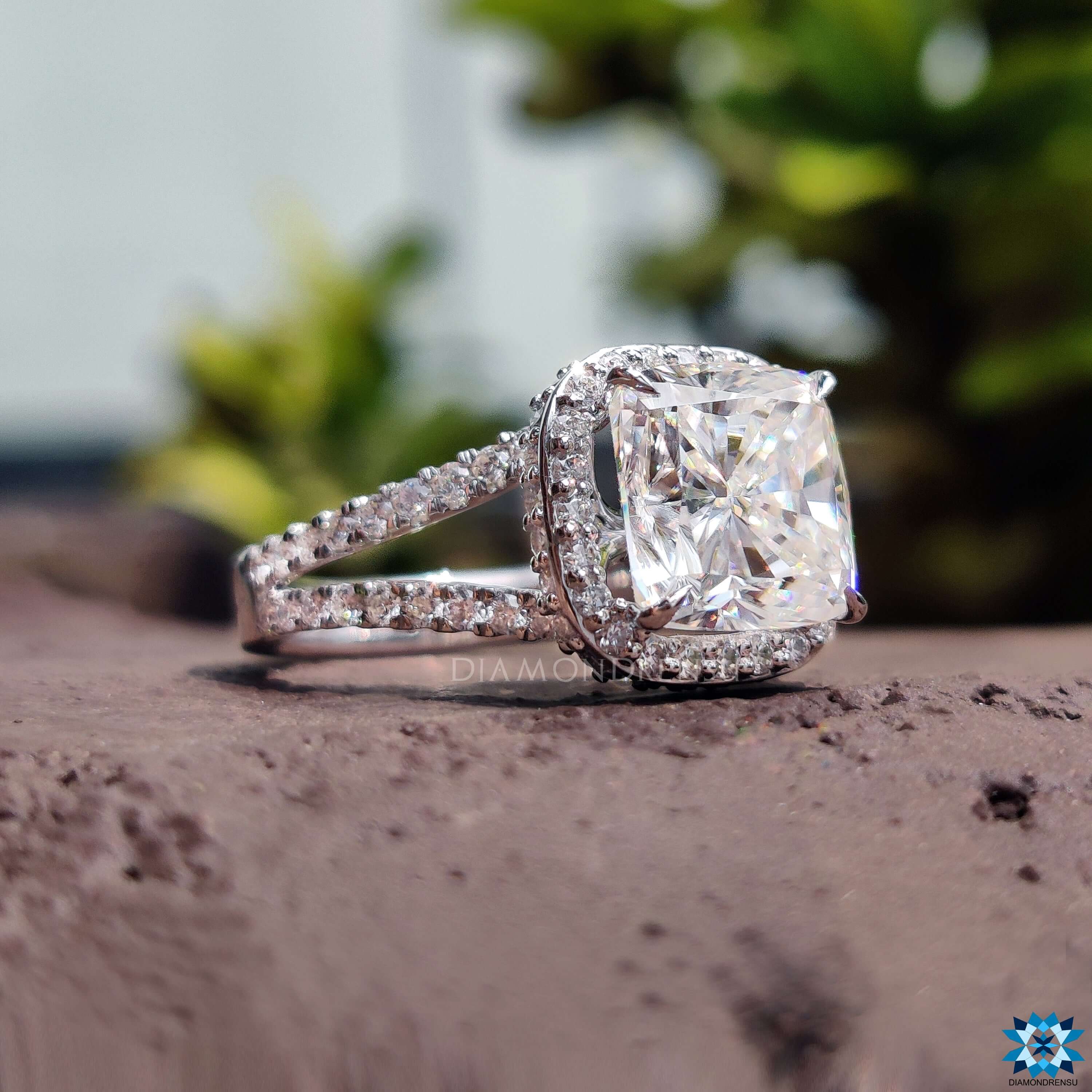 Handmade cushion cut moissanite ring with round side stones.