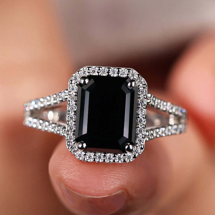 Black emerald cut moissanite engagement ring in white gold with halo setting.