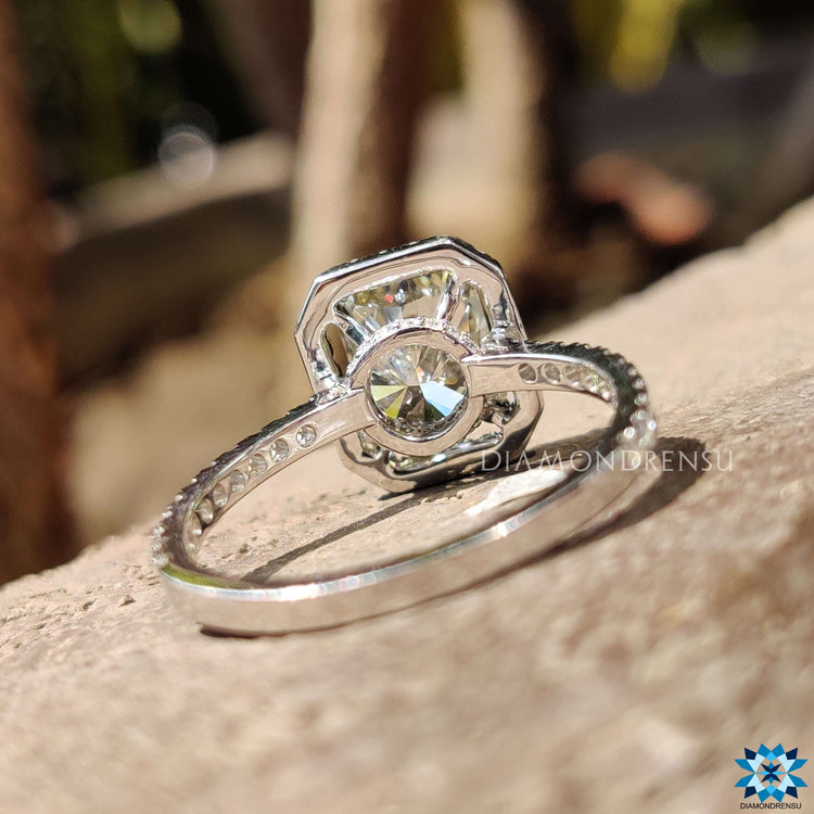 Moissanite pave ring with greenish yellow centre and halo frame.