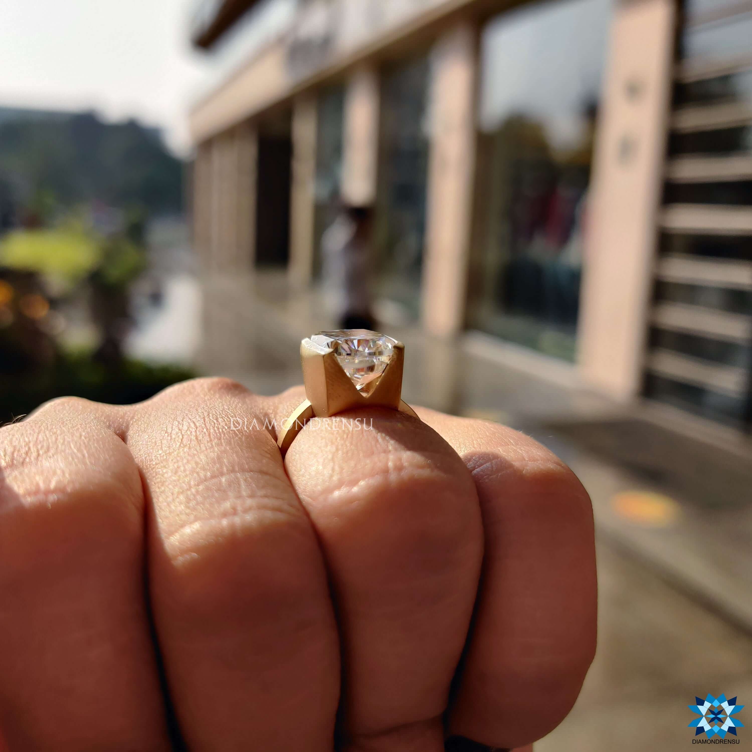 Yellow gold ring featuring elongated cushion cut moissanite.