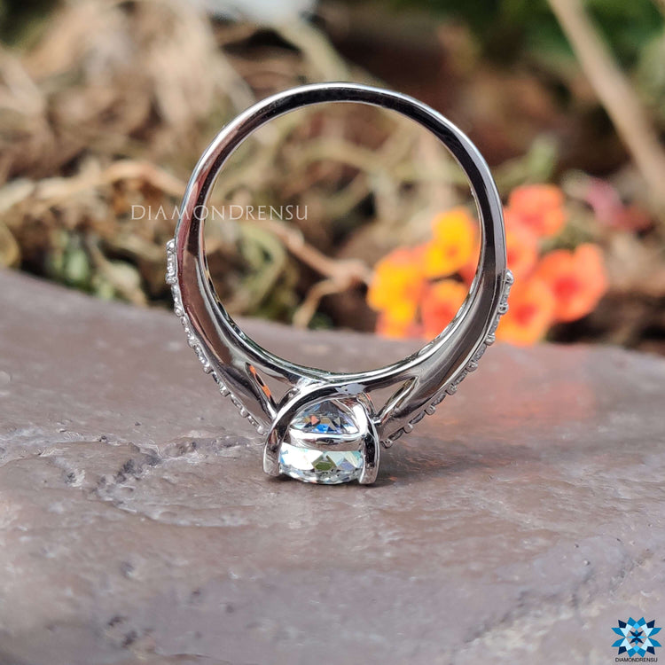 Custom engagement ring with pave band and round center.