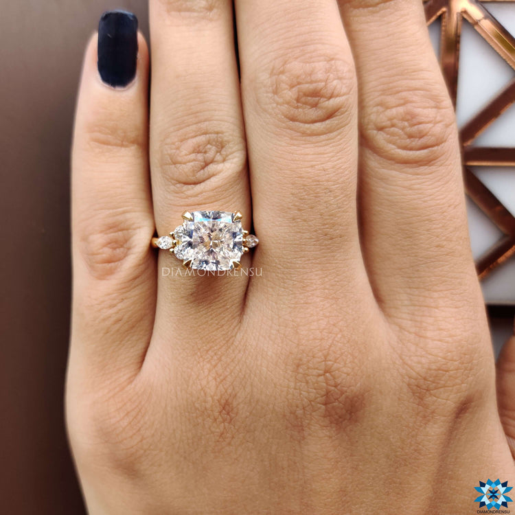 Custom engagement ring with cushion moissanite centre and 4 claw prong setting.