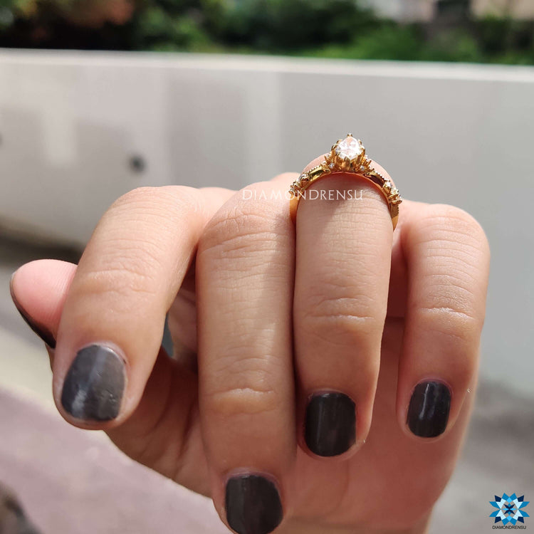 Elegant yellow gold moissanite ring with milgrain design.