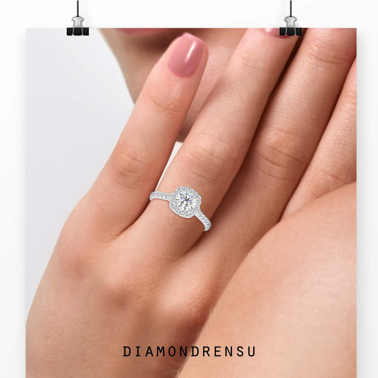 Round halo engagement ring in yellow gold.