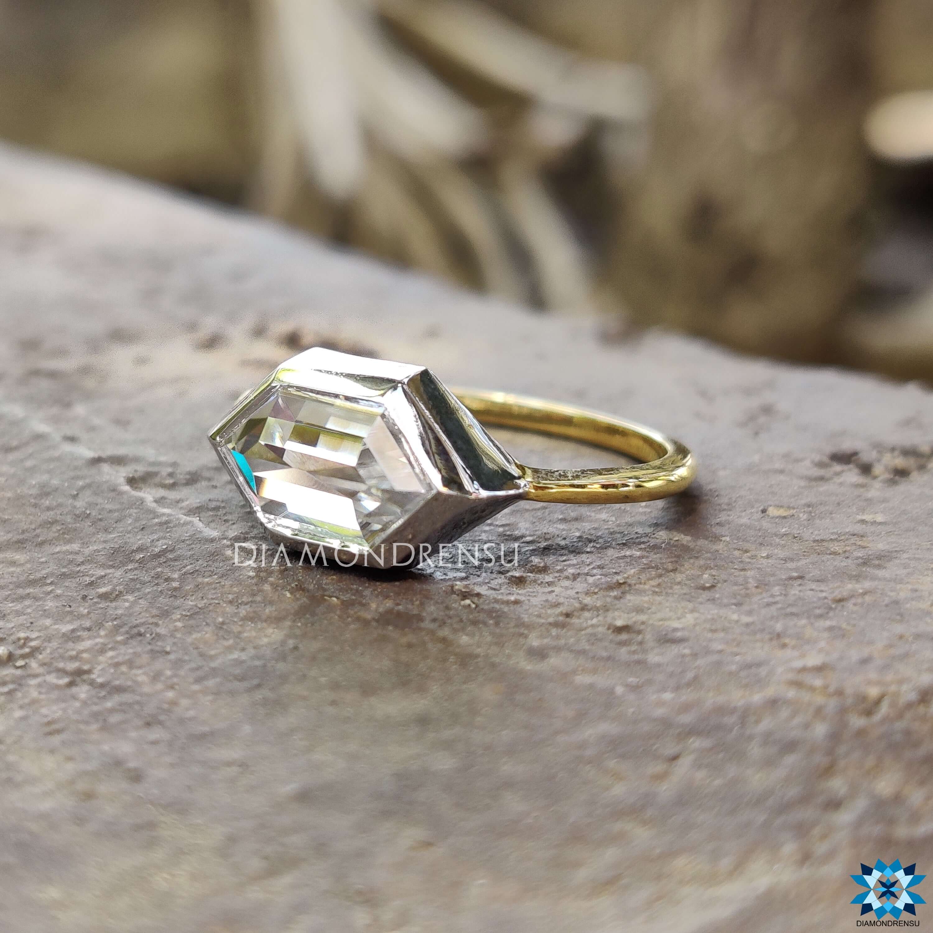 Bezel setting engagement ring with hexagon moissanite center.