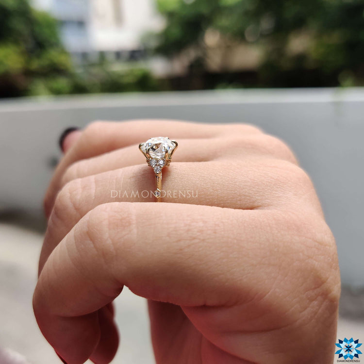 Custom engagement ring with old European moissanite and round accents.