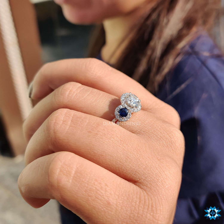Custom white gold engagement ring with halo and blue sapphire.