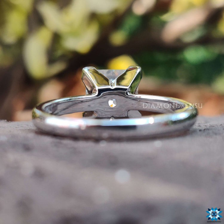 Minimalist engagement ring with princess moissanite center.