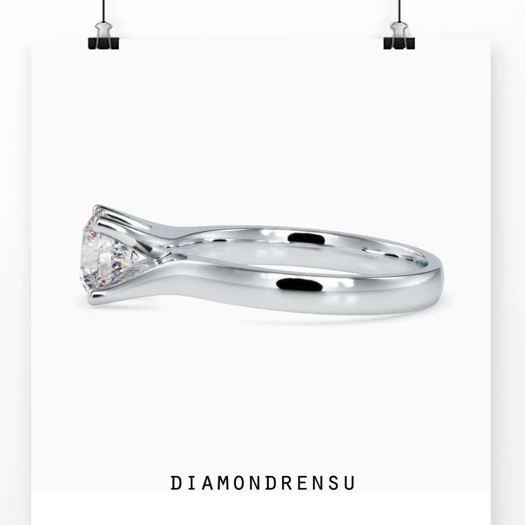 White gold ring with four round prong diamond setting.