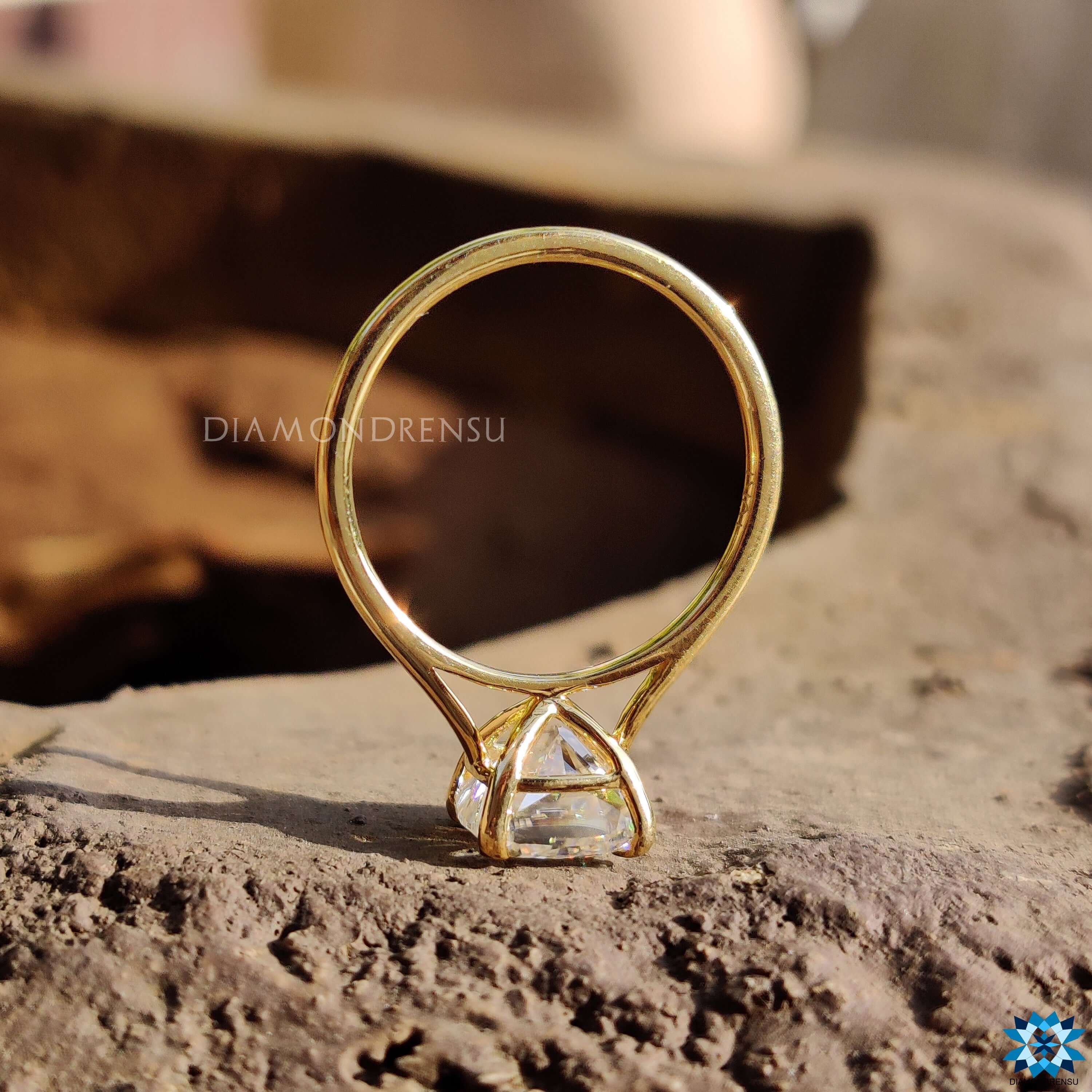 Yellow gold moissanite ring in cathedral mount.